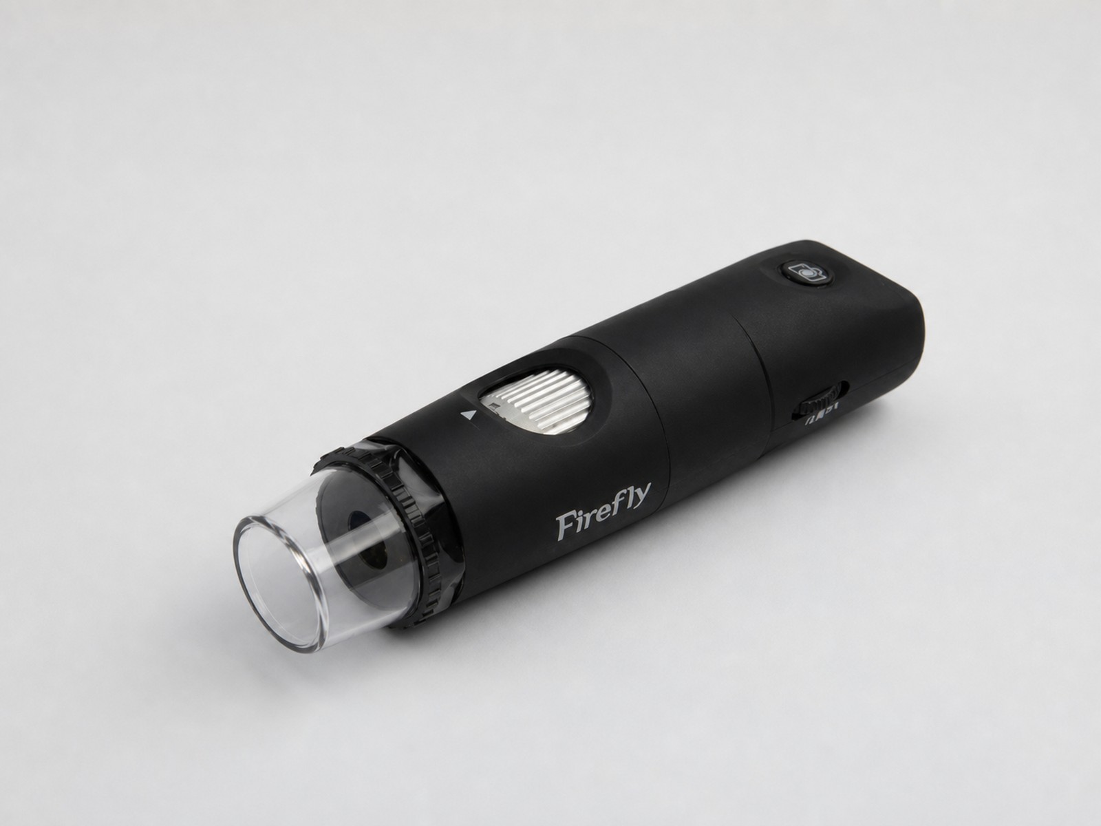Firefly USB Dermascope photographed in a clean clinical studio setting